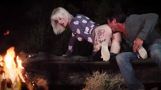 Blonde with tattoos and boyfriend enjoy sex by burning fire