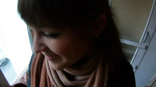 Naughty Russian wench with bangs gives blowjob on stair platform