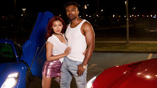 Black racer receives a hot blowjob and fucks a busty redhead