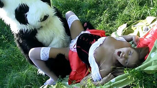 Guy in a panda suit is penetrating a busty woman in the field