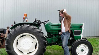 The Latino hunk is helping a man who has a broken tractor