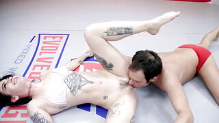 Brunette with lots of tattoos wrestling with a tall perv