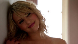 A sexy chick with tan lines is sitting on her ass and playing alone