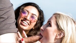 Busty blonde and brunette share cock and fuck on the beach