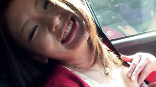 Horny Japanese girl is showing her lovely titties in the car