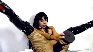 Exotic woman in fishnets slams that huge sex toy inside