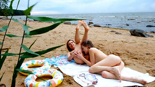 Adventurous lesbian couple gets busy and naughty on the beach