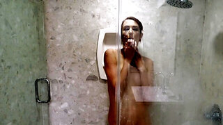 Redhead girl is fingering her pussy and asshole under the shower