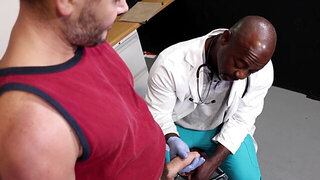 Muscular black man is checking out the pale patient