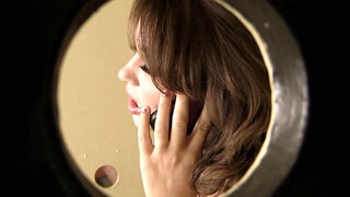 A brunette performs oral sex on a large thick penis in the toilet