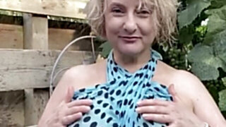 Hot mature blonde teases with her huge tits outdoors
