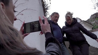 A blonde and a brunette having sex with an older man