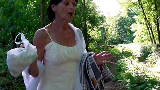 Older woman masturbates and fucks in the forest