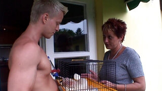 Redheaded granny is devouring a young stiff penis