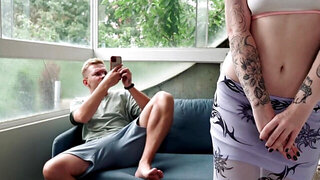 A tattooed redhead is filmed by her boyfriend