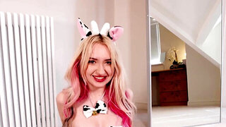 Kitty Marie wears a cow outfit while playing with a toy