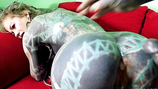 Body painted couple is having hardcore copulation on the couch