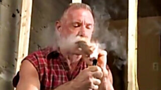Scott Reynolds smokes a cigar while playing with his cock