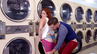 Naughty boy stretches curvy redhead in empty laundromat