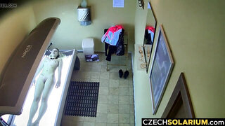 Girl relaxes in solarium not knowing about hidden cams