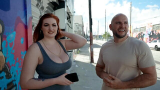 Bald stud fools around with curvaceous redhead in the streets