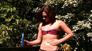 Sunbathing by the pool and rubbing her nice shaved muff