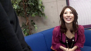 Japanese cutie with lovely smile talks on camera before shoot