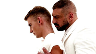 A man in a suit is banging the hell out of a petite lad