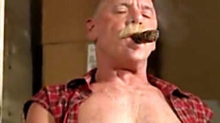 Scott Reynolds smokes a cigar while playing with his cock