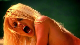 A blonde with large tits feels a cock inside her pussy on the sand