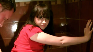 A sexy woman is in the public restroom, making a sex tape video