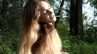 Lollipop-loving redhead gets naked and plays in the woods