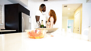 A black man receiving a sloppy blowjob in the kitchen