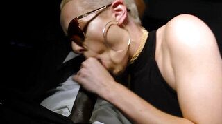 Short-haired blonde is riding a black cock in a car