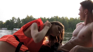 Seductive temptress is giving a blow job on the boat to a guy