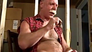 Scott Reynolds smokes a cigar while playing with his cock