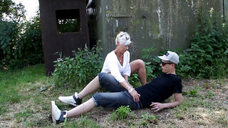 Short-haired MILF sucks and rides young cock outdoors
