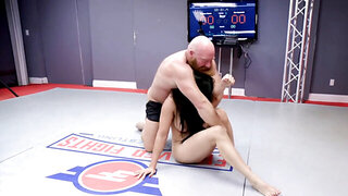 Bald fighter fucks brunette babe with big boobs on wrestling mat