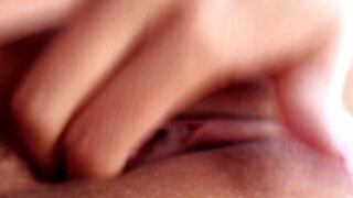 A babe with natural tits is placing her hand inside her meaty pussy