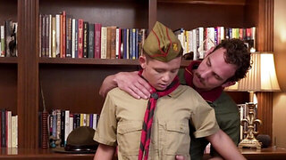 Chiseled scoutmaster with a moustache plays with a lad