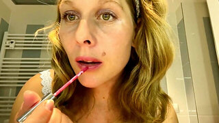 Ugly mom fondles her boobs while putting her make up on