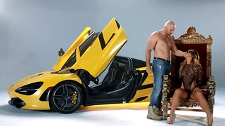 Owner of round booty analyzed by bald bruiser near luxury car
