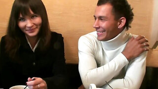 Three people are having fun at a sushi bare after closing time