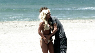 A blonde with large tits is penetrated hard on the bed in this video