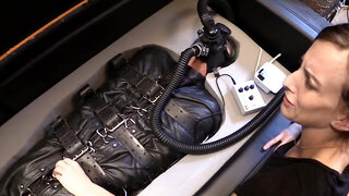 Brunette makes vibrator in tushy of man confined in leather buzz