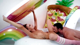 Skinny nymph and man make love in room full of inflatable toys