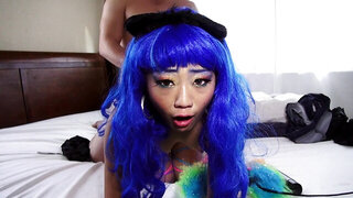 A bitch with blue hair is getting her pussy pounded on the sheets