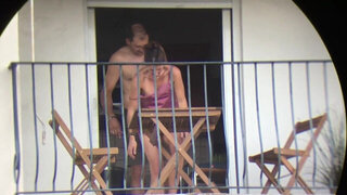 Voyeur catches his neighbors fucking on the balcony