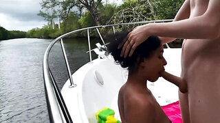 Exotic teen stretched on the boat by her excited white friend