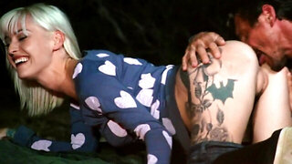 Inked blonde with big tits drilled by man outdoors near fire
